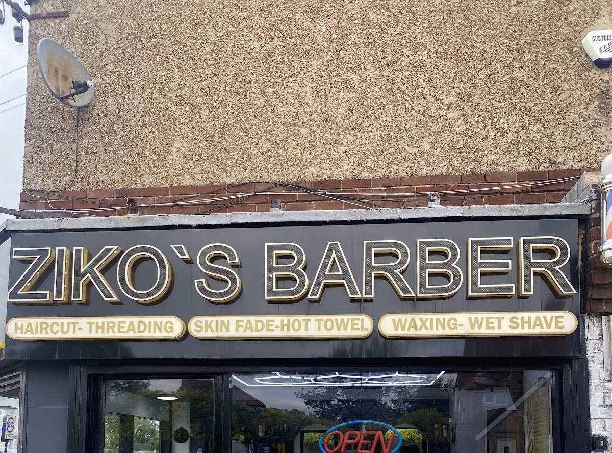 Ziko's Barber Shop signage: haircut, threading, skin fade, hot towel, waxing and wet shave