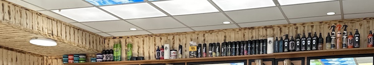 Wood panelled walls and the product shelf inside Ziko's Barber Shop