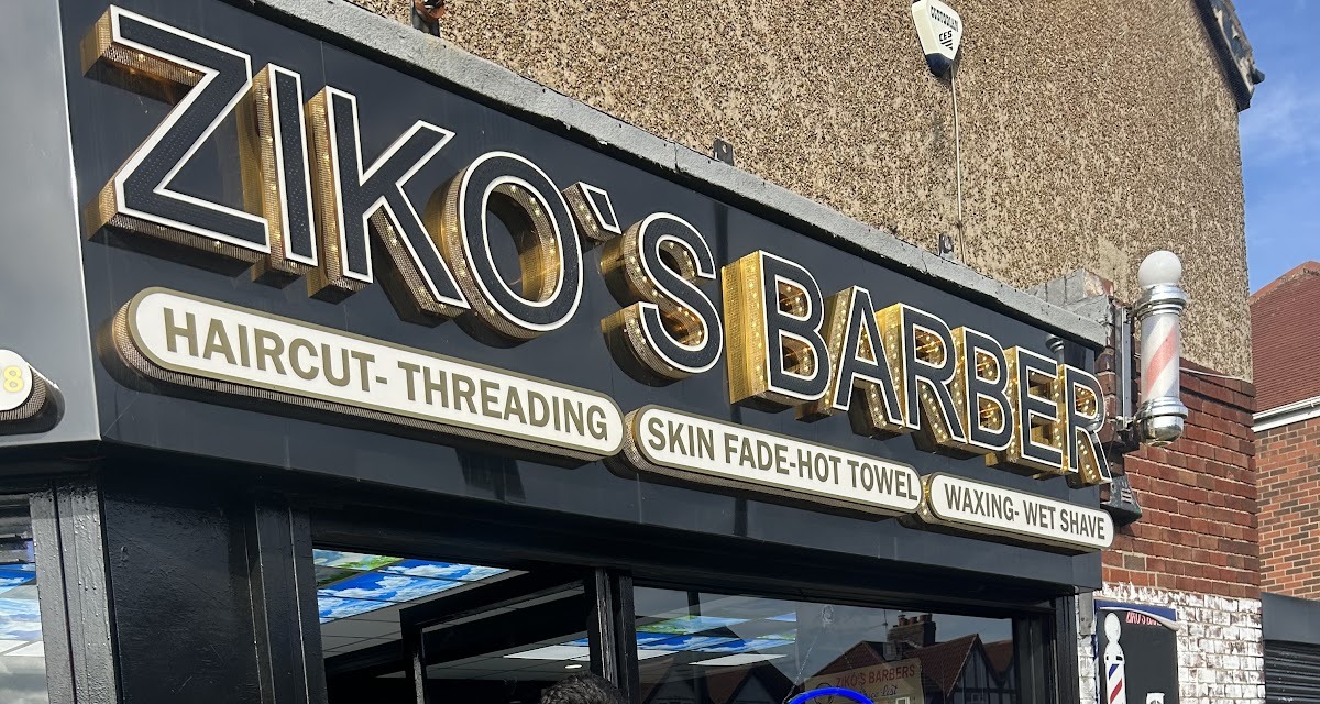 Ziko's Barber Shop shopfront and barber pole against a blue sky on Earsdon Road